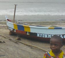 A fishing boat and a young girl. Taken in a Ghanaian fishing village.